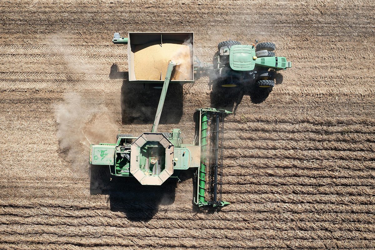 top down aerial view of a tractor and compound in a field